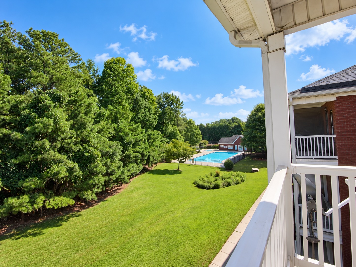Private balcony view toward pool and tennis courts